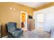 Cozy main bedroom showcasing an accent chair, walk-in closet, and entry to the ensuite bathroom at 420 Aloha Dr, Henderson, NV 89015