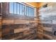 Stylish shower featuring wood-style tile, sleek hardware, and decorative shelving at 420 Aloha Dr, Henderson, NV 89015