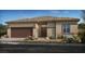 Charming single story home boasts neutral color palette, desert landscaping, and two-car garage at 4350 E Brusca Way, Pahrump, NV 89061