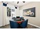 A stylish game room featuring a poker table, four chairs, a window, and a motorcycle art piece at 4350 E Brusca Way, Pahrump, NV 89061