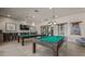 Game room with pool tables, TV, bar-height seating, and modern lighting for entertainment at 4350 E Brusca Way, Pahrump, NV 89061