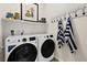 A clean laundry room featuring a new washer and dryer, storage shelf, and towel rack at 4350 E Brusca Way, Pahrump, NV 89061