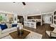 Open-concept living area featuring a kitchen island with bar stools, flowing into living room at 4350 E Brusca Way, Pahrump, NV 89061