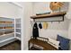 Mud room entrance features storage shelves, wooden bench with decorative pillows and coat rack at 4350 E Brusca Way, Pahrump, NV 89061