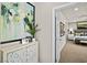 Hallway leading to bedroom with decorative artwork, a cabinet and a plant at 4365 E Brusca Way, Pahrump, NV 89061