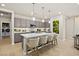 Modern kitchen featuring a large island with bar seating and stainless-steel appliances at 4365 E Brusca Way, Pahrump, NV 89061