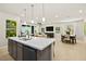 Bright, open kitchen with island seating, stainless steel appliances, and ample counter space at 4365 E Brusca Way, Pahrump, NV 89061