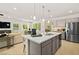Spacious kitchen island with bar seating, pendant lights, and stainless steel sink at 4365 E Brusca Way, Pahrump, NV 89061