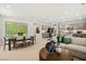 Open-concept living area with a dining table and view into modern kitchen at 4365 E Brusca Way, Pahrump, NV 89061