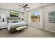 Serene bedroom with neutral tones, ceiling fan, and an abundance of natural light at 4365 E Brusca Way, Pahrump, NV 89061