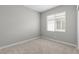 Clean, carpeted bedroom with window and neutral decor at 4412 Cave Lake Ave, North Las Vegas, NV 89032