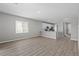 Open living space with wood-look floors, light gray walls, leading into a kitchen area at 4412 Cave Lake Ave, North Las Vegas, NV 89032