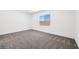 Bedroom with neutral carpet, a large window, and a view of the privacy wall at 4450 E Brusca Ct, Pahrump, NV 89061