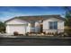 Charming single-story home featuring a two-car garage, neutral tones, and desert landscaping at 4450 E Brusca Ct, Pahrump, NV 89061
