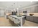 Spacious kitchen with modern appliances, ample gray cabinetry, and a large center island with barstool seating at 4450 E Brusca Ct, Pahrump, NV 89061