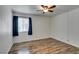 The bedroom has a ceiling fan and wood-look flooring at 5240 Indian River Dr # 273, Las Vegas, NV 89103