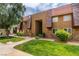 Attractive condo building with lush lawn, mature tree, and cozy front garden at 5240 Indian River Dr # 273, Las Vegas, NV 89103