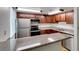 Well-lit kitchen features stainless steel appliances, granite countertops, and updated wood cabinets at 5240 Indian River Dr # 273, Las Vegas, NV 89103