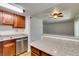 Updated kitchen with view into living area featuring stainless dishwasher and granite countertops at 5240 Indian River Dr # 273, Las Vegas, NV 89103