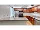 Well-lit kitchen features stainless steel appliances, granite countertops, and updated wood cabinets at 5240 Indian River Dr # 273, Las Vegas, NV 89103