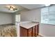 Updated kitchen with view into living area with sliding door and wood-look floors at 5240 Indian River Dr # 273, Las Vegas, NV 89103