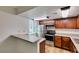 Well-lit kitchen features stainless steel appliances, granite countertops, and updated wood cabinets at 5240 Indian River Dr # 273, Las Vegas, NV 89103