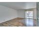 Spacious living area featuring wood floors and a sliding glass door to balcony at 5240 Indian River Dr # 273, Las Vegas, NV 89103