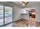 Open living room with wood floors, connecting to a kitchen and a sliding door to the outside at 5240 Indian River Dr # 273, Las Vegas, NV 89103