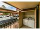 Enclosed patio with utility closet containing a washer and dryer hookup, looking out to assigned, covered parking at 5240 Indian River Dr # 273, Las Vegas, NV 89103