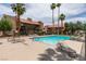 Inviting community pool surrounded by lounge chairs for relaxation and mature palm trees at 5240 Indian River Dr # 273, Las Vegas, NV 89103