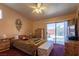 Spacious bedroom with ceiling fan, and a sliding glass door that leads to the backyard pool at 6242 Halehaven Dr, Las Vegas, NV 89110