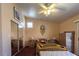 Cozy bedroom featuring a ceiling fan, carpeted floors, and ample closet space at 6242 Halehaven Dr, Las Vegas, NV 89110