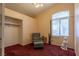 Well-lit bedroom with a comfortable chair, providing a cozy retreat within the home at 6242 Halehaven Dr, Las Vegas, NV 89110