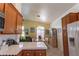 Bright kitchen and dining area with tile floors, wood cabinets, and white appliances at 6242 Halehaven Dr, Las Vegas, NV 89110