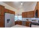 Well-maintained kitchen with wood cabinets, white appliances, and tiled countertops at 6242 Halehaven Dr, Las Vegas, NV 89110