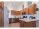 Functional kitchen with wood cabinets, tile countertops, and modern appliances at 6242 Halehaven Dr, Las Vegas, NV 89110