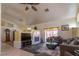 Cozy living room featuring a fireplace, comfortable seating, and tiled floors at 6242 Halehaven Dr, Las Vegas, NV 89110