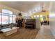 Bright living room featuring wood-look floors, comfortable seating, and natural light at 6242 Halehaven Dr, Las Vegas, NV 89110