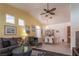 Open-concept living and dining area with tile floors, neutral walls, and comfortable seating at 6242 Halehaven Dr, Las Vegas, NV 89110