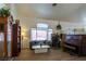 Inviting living room features wood-look floors, a large window, and comfortable seating at 6242 Halehaven Dr, Las Vegas, NV 89110