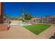 Inviting backyard with pool, artificial turf, and lush landscaping perfect for outdoor entertaining at 6330 Spring Meadow Dr, Las Vegas, NV 89103