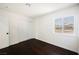 Bedroom with wood flooring, closet with doors, and a window at 6330 Spring Meadow Dr, Las Vegas, NV 89103