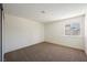 Comfortable bedroom featuring neutral carpet, fresh paint, and a window offering natural light and neighborhood views at 6330 Spring Meadow Dr, Las Vegas, NV 89103