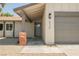Inviting home exterior with a brick accented entrance and a well-maintained garage door at 6330 Spring Meadow Dr, Las Vegas, NV 89103