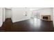 Open living room with hardwood floors, fireplace, neutral paint, and sliding glass door to backyard at 6330 Spring Meadow Dr, Las Vegas, NV 89103