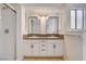 Bathroom features a modern double vanity, framed mirrors, and a shower and tub combo at 6521 Faith Peak Dr, Las Vegas, NV 89108