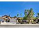Charming single-story home with a well-manicured lawn, mature trees, and attached two-car garage at 6521 Faith Peak Dr, Las Vegas, NV 89108