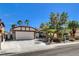 Single-story home with mature landscaping, desert plants, and a two-car garage at 6521 Faith Peak Dr, Las Vegas, NV 89108