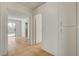 Hallway with tiled floors, leading to backyard with bright sunny views through sliding glass doors at 6521 Faith Peak Dr, Las Vegas, NV 89108