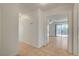 Hallway features tiled floors, leading to a room with bright backyard views through sliding glass doors at 6521 Faith Peak Dr, Las Vegas, NV 89108